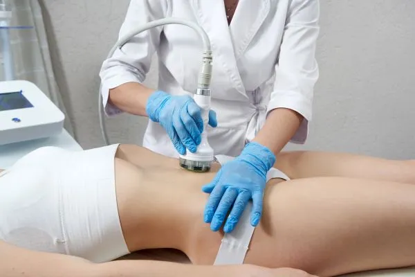 Lost the Weight but Not the Loose Skin? 2 woman having HIFU treatment on her stomach to combat loose skin Herefordshire following weight loss